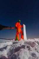 Snowboarder making a selfie by his action camera on the top of the ski slope photo