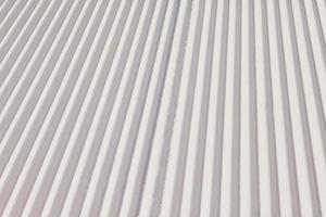Texture of new groomed snow on empty ski slope photo