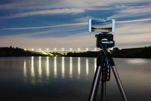 Using smartphone like professional camera on tripod to capturing night landscape photo