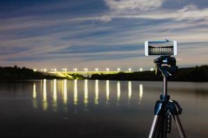 Using smartphone like professional camera on tripod to capturing night landscape photo