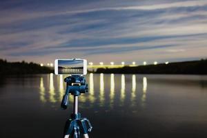 Using smartphone like professional camera on tripod to capturing night landscape photo