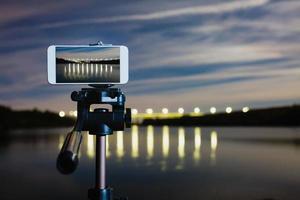 Using smartphone like professional camera on tripod to capturing night landscape photo