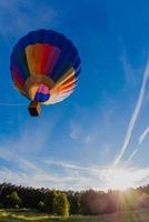 Colorful hot air balloon in blue sky photo