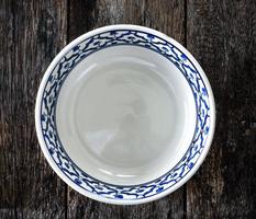 empty white plate on wooden photo