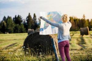 Lost Woman on a Rural Scene Looking at a Map photo