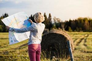 Lost Woman on a Rural Scene Looking at a Map photo