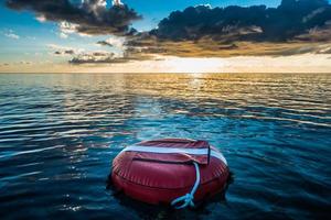 Red buoy for freediving floating in the ocean. photo