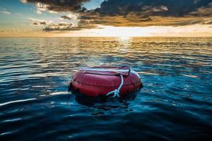 Red buoy for freediving floating in the ocean. photo