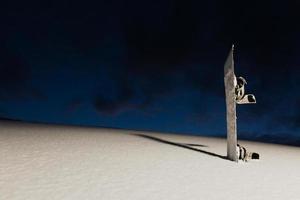 Powder texture and snowboard at sunset photo