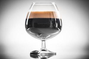 Homebrew Stout Dark or Black Beer over Bright Background photo