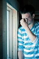 Young man at the window photo