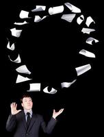 Businessman manipulating sheets of paper photo