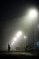 Woman alone in the foggy street
