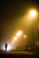 Woman alone in the foggy street