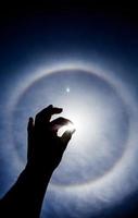 Hand silhouette with Circular Sun Halo photo