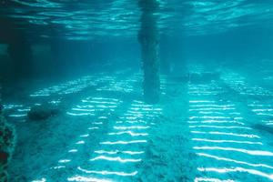 Underwater view of Under a Pier with Pillars and Sun Light photo