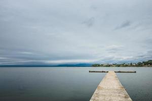 Wooden pier at ocean in cloudy day in Gaspe. photo