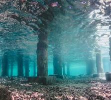 Underwater view of Under a Pier with Pillars and Sun Light photo