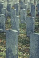 Back of Army Headstone and Graveyard Cemetery during a Sad Day of Autumn. photo