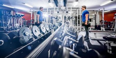 Man in gym with barbell photo