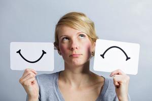 Portrait of a Person Holding Happy and Unhappy Mood Board photo