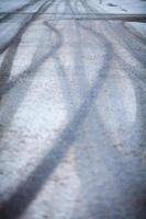 Snow-covered road, the marks of wheels photo