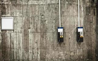 Public phones on concrete wall photo