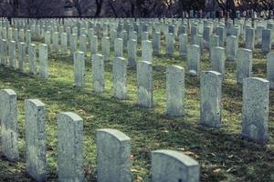 Back of Army Headstone and Graveyard Cemetery during a Sad Day of Autumn. photo