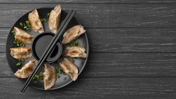 traditional dumplings plate with chopsticks photo