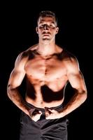 Muscular man on black photo