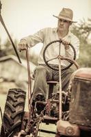 Young Farmer on a Vintage Tractor photo