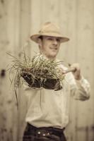 Farmer with a Shovel Full of Grass photo