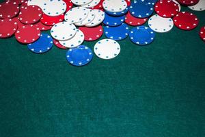 white blue red casino chips green background photo