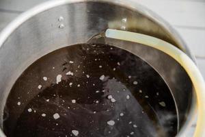 Pouring Craft Home Brew Beer Wort into the Boil Kettle photo