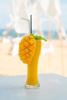 mango smoothies with sea beach background photo
