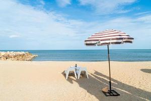 patio outdoor table and chair on beach with sea beach background photo
