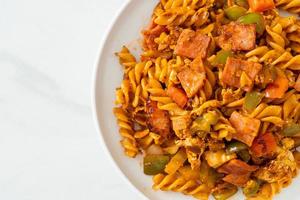 fusilli pasta with ham and tomatoes sauce photo