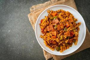 fusilli pasta with ham and tomatoes sauce photo