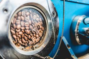 Beans in small window of coffee roaster photo