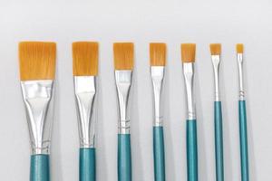 Set of paintbrushes on white canvas background. Artist tool photo