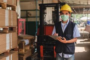 Worker checking raw material inventory in  factory