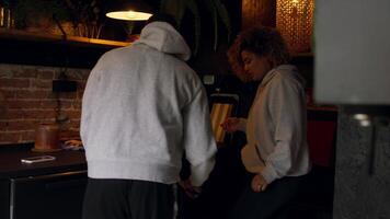 Woman and man in kitchen preparing meal video