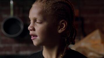 Close up of boy turning head from daylight smiling to camera lens video