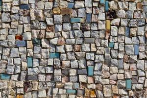 textura de mosaico del pequeño muro de piedra foto