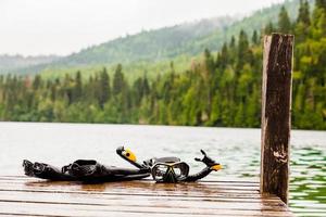 Snorkeling Mask and Tuba on Dock photo