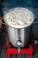 Homebrewing Hot Break and lot of Protein Froth on to of the Boil Kettle Warming up. photo