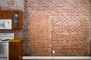 Industrial Old Flat Brick Wall Perspective in a kitchen. photo