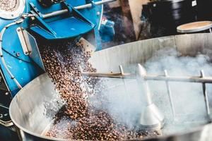 Roasted coffee beans steaming in cooling cylinder photo