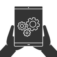 Hands holding tablet computer glyph icon. Device settings. Silhouette symbol. Tablet computer with cogwheels. Negative space. Vector isolated illustration