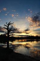 Romantic sunset with unique reflections on a peaceful lake photo